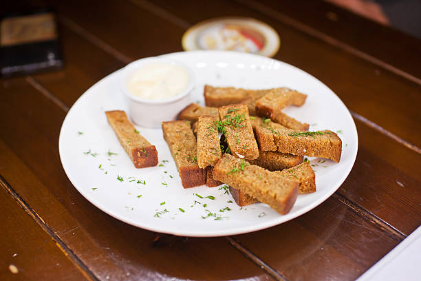 Plate with fried bread with sauce and dill stock photo