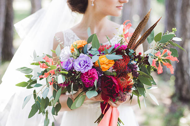 colorful bouquet in boho style in the bride's hands - bouquet wedding bride single flower imagens e fotografias de stock