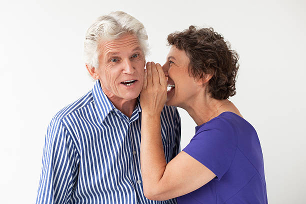 istock Excited mature woman whispering secrets 637329796