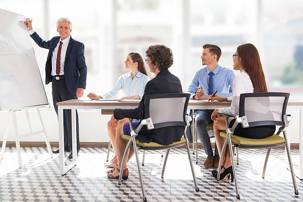 istock Smiling senior businessman conducting presentation 637330076