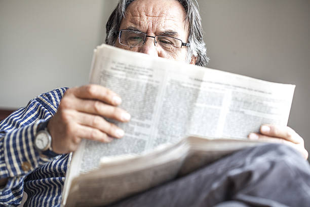 istock Senior man reading newspaper 637330344