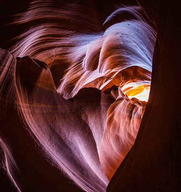 heart shaped skylight in desert canyon letting light into darkness - rock strata natural pattern abstract scenics imagens e fotografias de stock