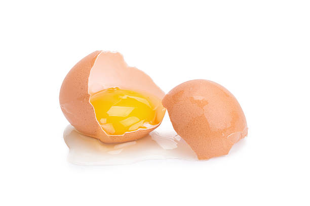 istock Close up of cracked egg on white background. 637334802