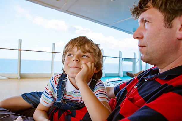 istock Little happy kid boy and father laughing on cruise ship 637337236