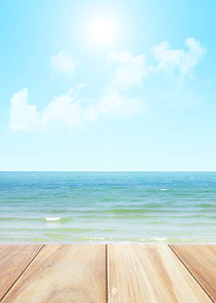 istock Close up wooden table with seascape blurred background 637338324