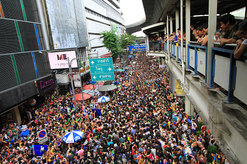 BANGKOK - APRIL 13: Crowd of people celebrating the traditional Songkran New Year Festival, April 13, 2014, Silom road, Bangkok, Thailand.