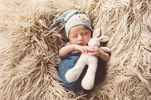Newborn Baby Sleeping with Bunny stock photo