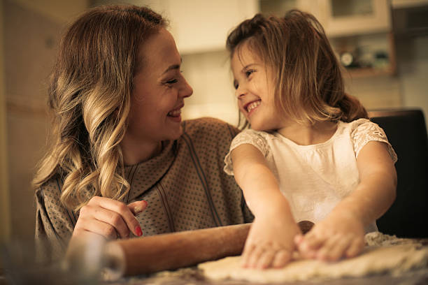 istock Mother and daughter baking cookies. 637351138