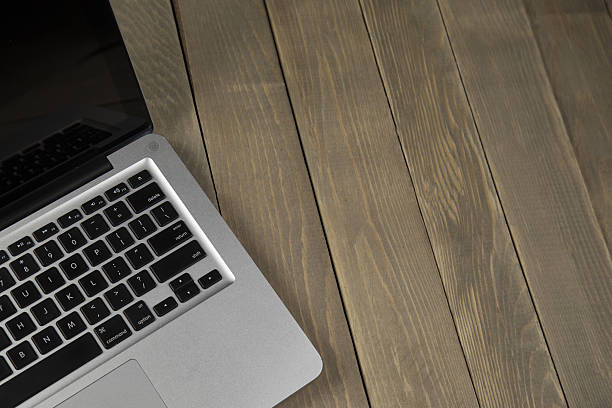 istock laptop on wood background 637351826
