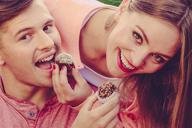 istock Smiling couple feeding each other. 637353934