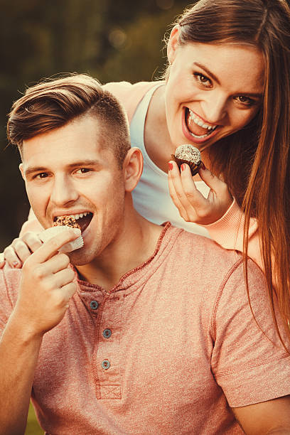 istock Lovely couple eating cupcakes. 637354018