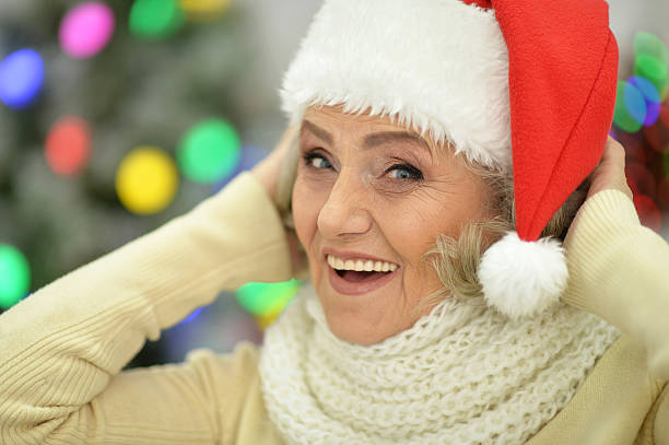 istock Senior woman in Santa hat 637354370