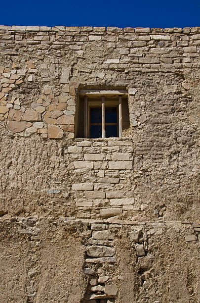 Acoma, United States - March 19, 2016: The Acoma Pueblo sits on a mesa 365 feet above the desert floor, with no running water or electricity available.  Having been consistently inhabited since the early 13th century, currently there are about 300 adobe and stucco homes there, with 30 year round residents.  Pictured here is the San Esteban Del Rey Mission, built by Spanish and the local residents with ponderosa pine hauled from Mount Taylor, 40 miles away.