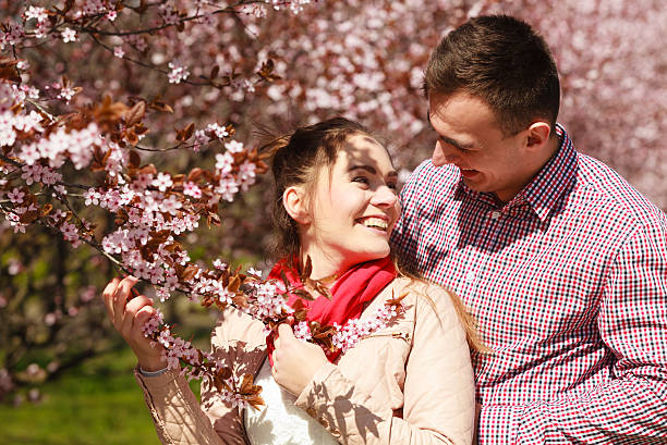 istock Couple in love walking in park at sunny spring day 637355684