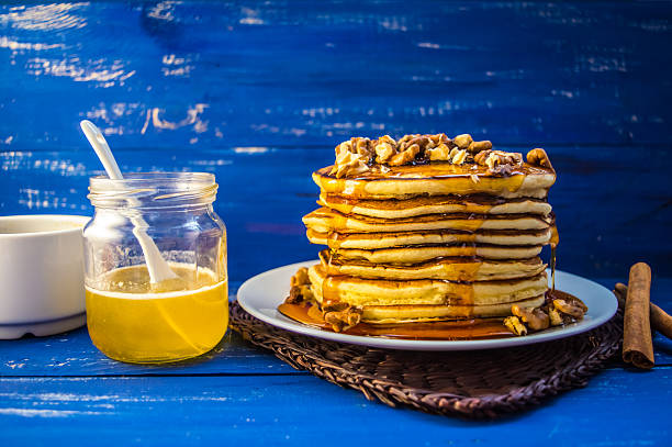 istock Pancakes with walnuts and maple syrup for breakfast. Close-up 637357012