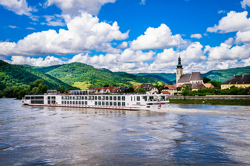 Saverne, France - May 26, 2022: Houseboat on Rhine-Marne Canal in Saverne. In background Old Episcopal Castle and Rohan Castle. Department Bas-Rhin in the Alsace region of France