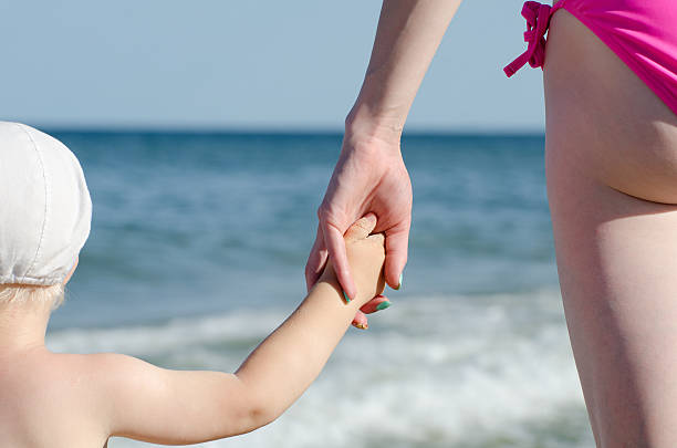 istock Mother keeps son by the hand 637360840