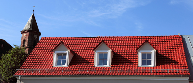 Red tile roof on a residential home with dormer