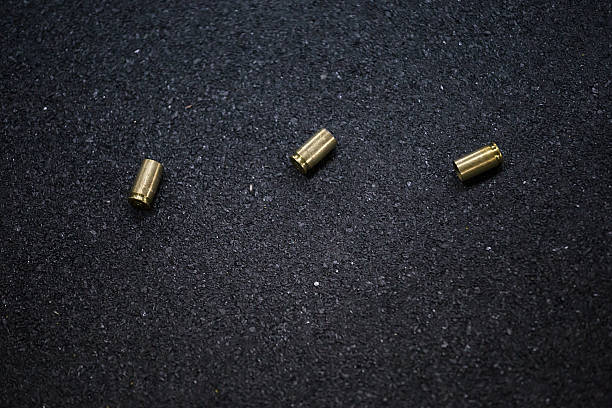bullet shells ground Cases of bullets lying on the floor of asphalt bullet cartridge photos stock pictures, royalty-free photos & images