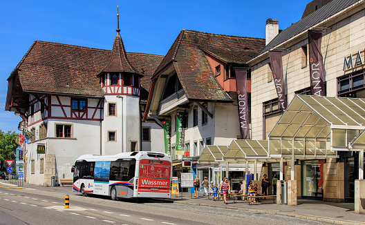 Aarau, Switzerland - 7 July, 2016: people, buildings and a bus on an old town street. Aarau is a town and municipality in Switzerland, it is the capital of the Swiss Canton of Aargau. 