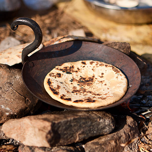 istock Indian men preparing chapatti bread during festival in Pushkar 637365110