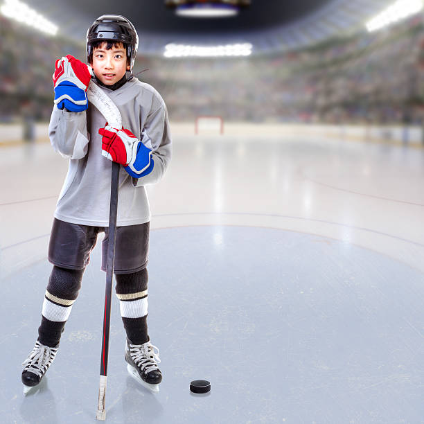 istock Junior Ice Hockey Player Posing in Arena With Copy Space 637365626