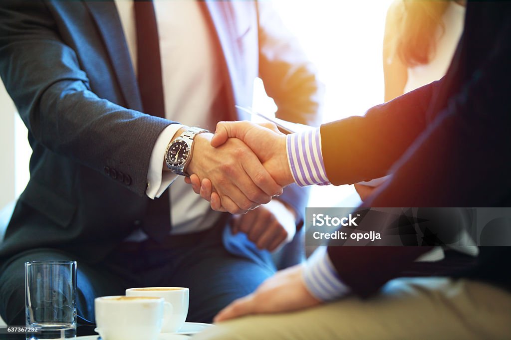 Business people shaking hands, finishing up a meeting. Business people shaking hands, finishing up a meeting Handshake Stock Photo