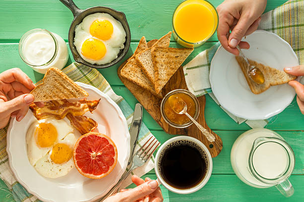 istock Family having summer breakfast, top view 637367346
