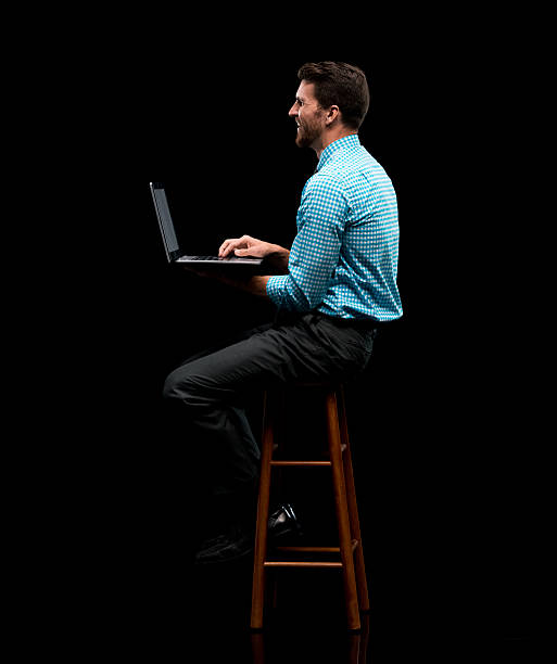 istock Smiling businessman working on laptop 637369024