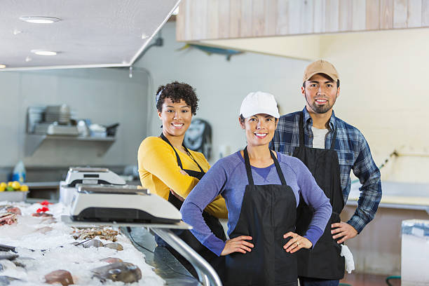 istock Team of workers in seafood market 637371478