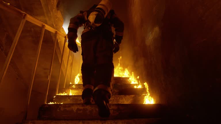 Brave Fireman Runs Up the Burning Stairs. Fire is Everywhere. In Slow Motion.