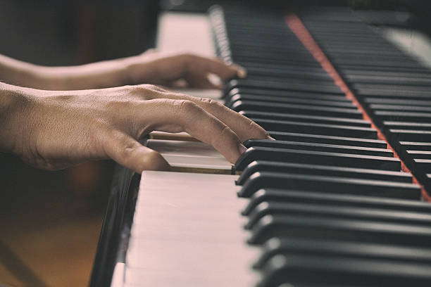 istock Woman playing piano 637378010