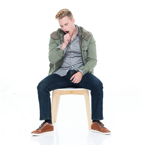 Man sitting on chair and yawning