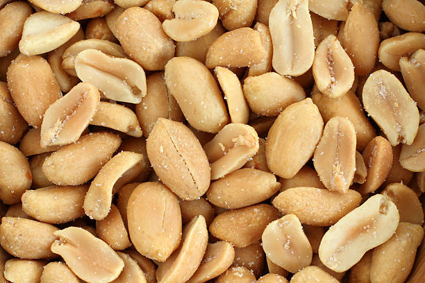 istock Food background - salted roasted peanuts situated arbitrarily 637381292