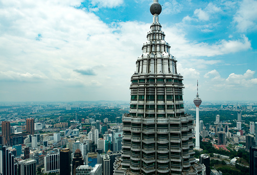 Daytime view at downtown Kuala Lumpur from a helicopter with the Petronas Tower in in the front.