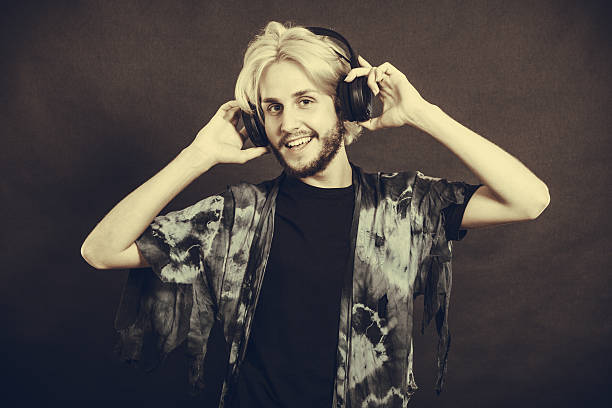istock Blonde man singing in studio wearing headphones 637384820