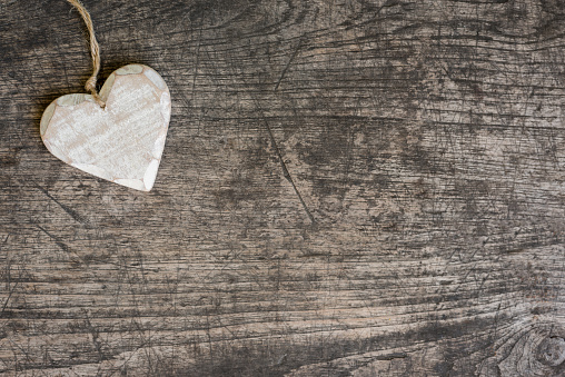 White wooden heart on rustic table with copy space