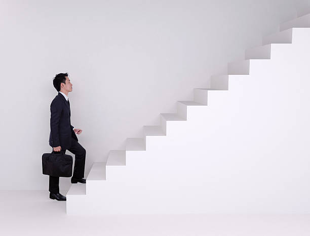 istock Business man stepping up on stairs 637385890