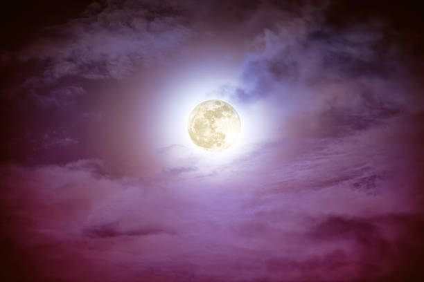 istock Nighttime sky with clouds and bright full moon with shiny. 637385896