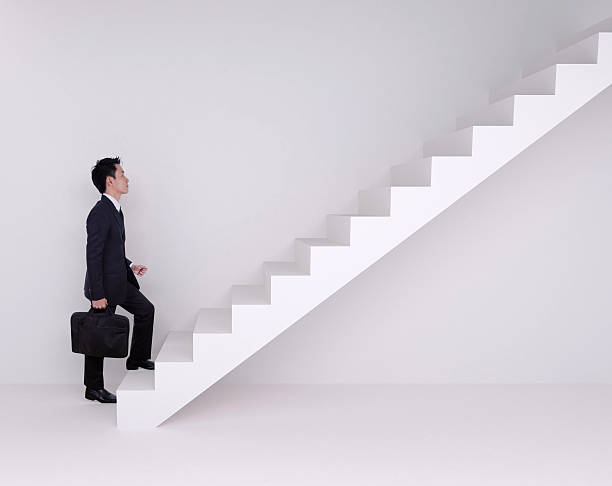 istock Business man stepping up on stairs 637385910