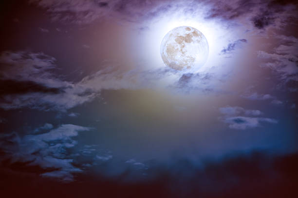 istock Nighttime sky with clouds and bright full moon with shiny. 637385918
