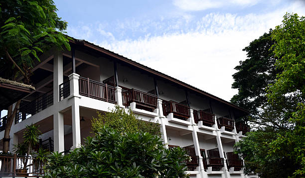 istock hotel building with tree and blue sky background 637390420
