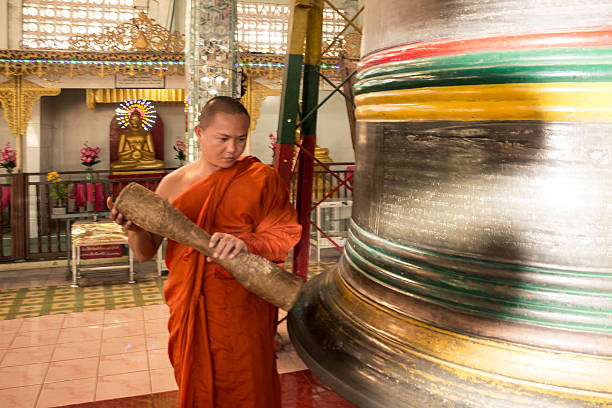 Buddhist hitting the yangon bell in Myanmar