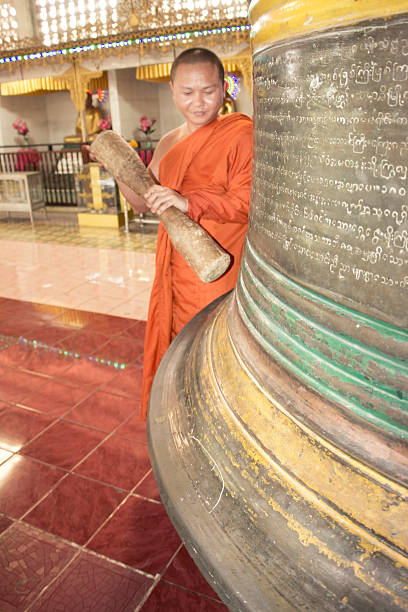 Buddhist hitting the yangon bell in Myanmar