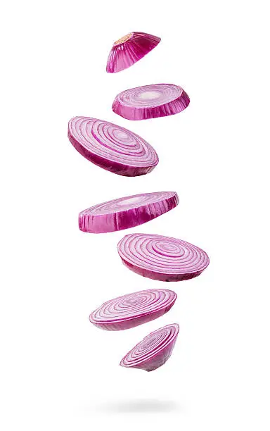 sliced and falling  red onion isolated on white background