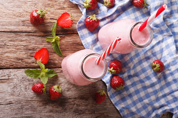 istock Refreshing strawberries smoothies in a glass bottle close-up 637395968