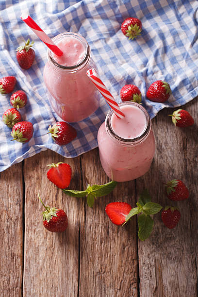 istock Refreshing strawberries smoothies in a glass bottle close-up 637396068