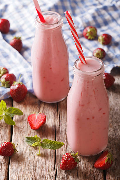 istock Freshly made strawberry smoothie in glass bottles close-up 637397084