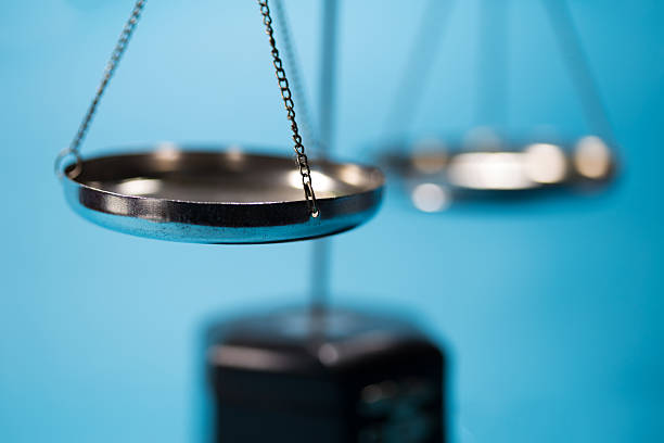 istock Silver scale of justice on wooden table in blue tone 637398510