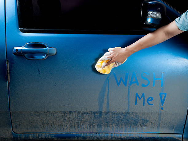 istock man washing a soapy blue car with a sponge. 637398598